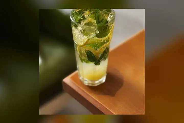 An iced mojito with fresh mint and lime