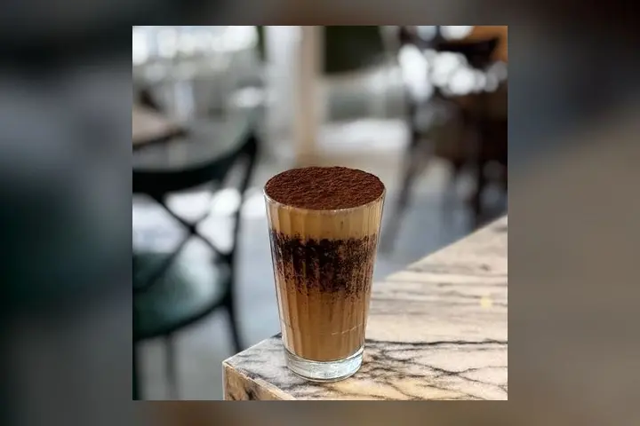 A tiramisu milkshake dusted with cocoa