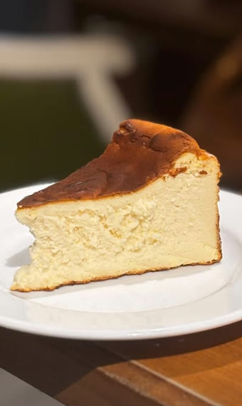 A slice of Basque cheesecake with a caramelised top